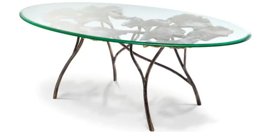 Poseidon Coffee Table by Eichholtz featuring dramatic sculptural gold Art Nouveau base with flowing floral elements and glass top